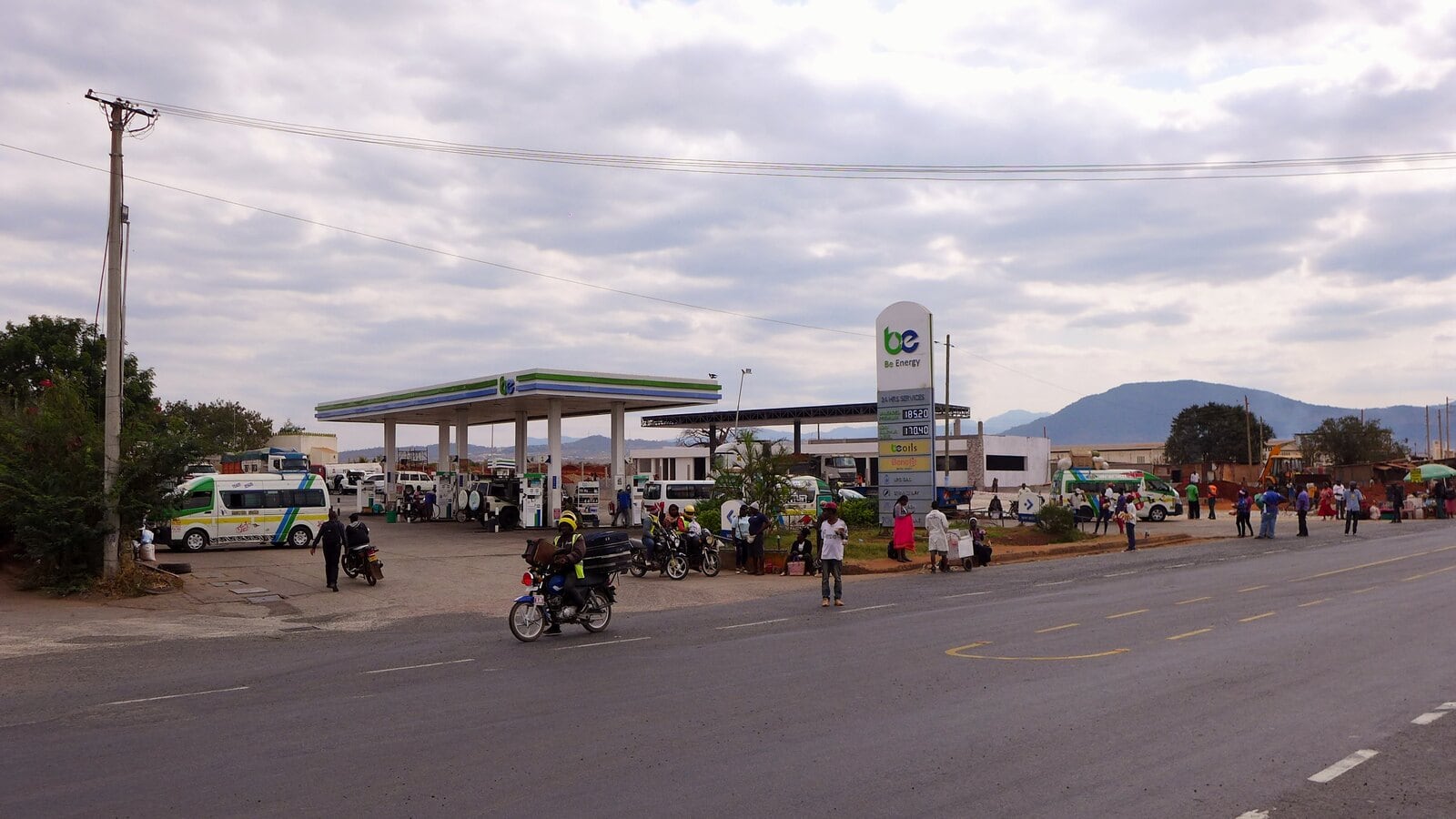 A petrol station in Voi with motorbikes and a matatu on the forecourt