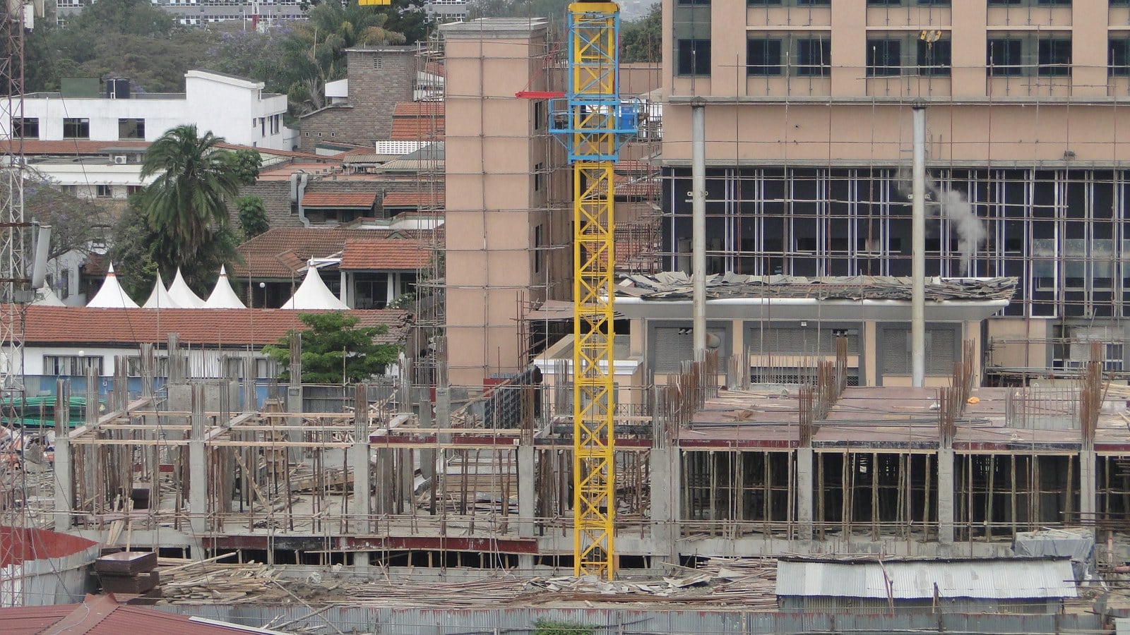 A tower crane over buildings going up in central Nairobi